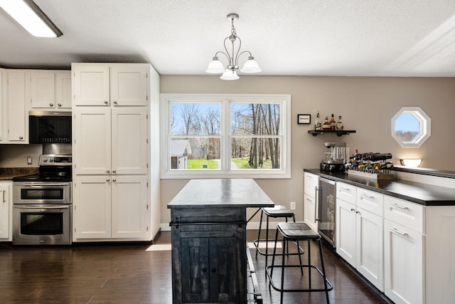 695 Pine Lake Ln, Bone Lake Twp, WI 54837 - kitchen featuring dark countertops, plenty of natural light, stainless steel appliances, and wine cooler