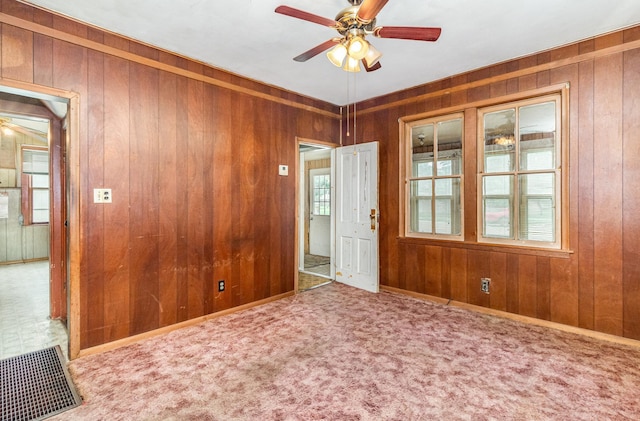 316 Main St, Belle Plaine, MN 56011 - empty room featuring ceiling fan, wood walls, and carpet