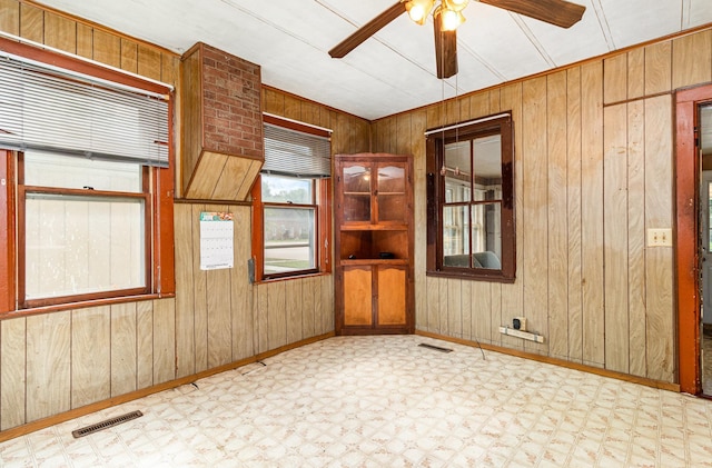 316 Main St, Belle Plaine, MN 56011 - unfurnished room with tile patterned floors, a ceiling fan, and wooden walls