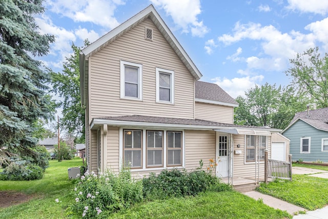316 Main St, Belle Plaine, MN 56011 - traditional-style house with a front yard, a garage, driveway, and roof with shingles