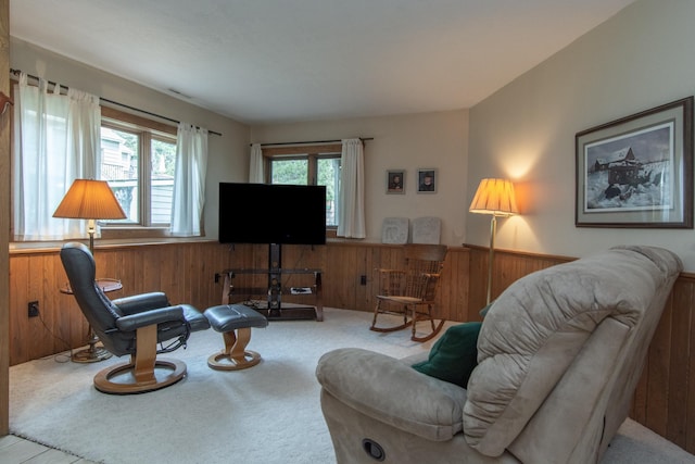 sitting room with carpet flooring, wood walls, and a wainscoted wall