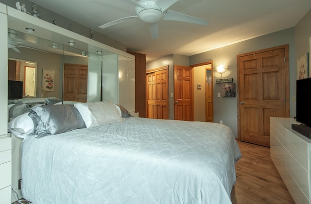 bedroom with light wood-style floors and ceiling fan