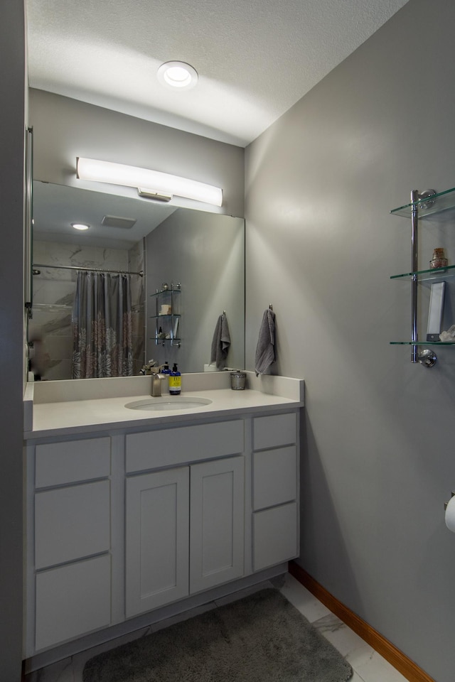 bathroom with vanity, baseboards, and a shower with shower curtain