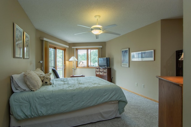 carpeted bedroom with baseboards, ceiling fan, and a textured ceiling