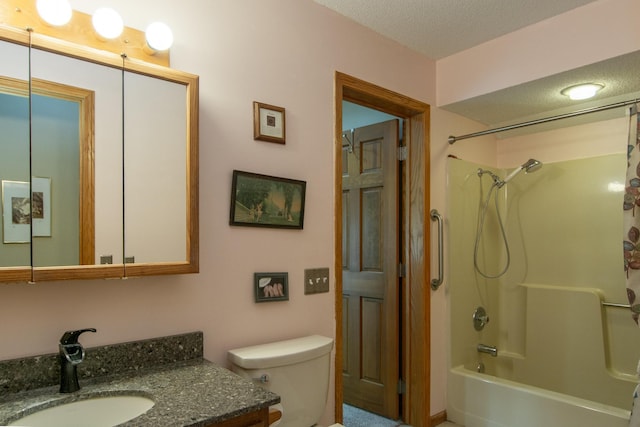 full bathroom featuring toilet, a textured ceiling, shower / bathing tub combination, and vanity