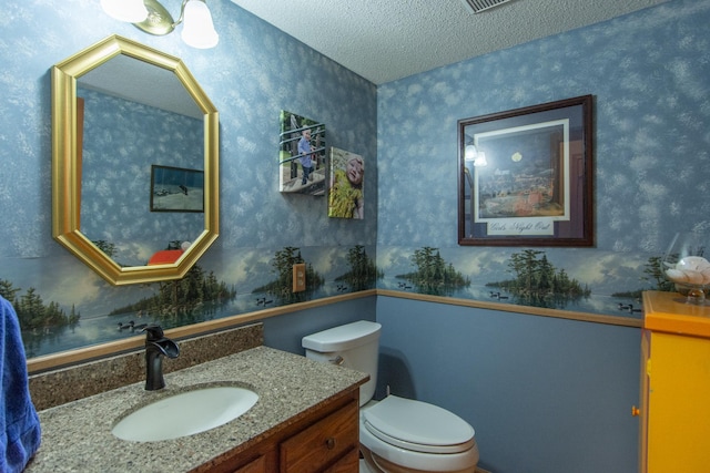 35533 Sand Pointe Dr Unit 6, Crosslake, MN 56442 - bathroom with vanity, a textured ceiling, toilet, and wallpapered walls