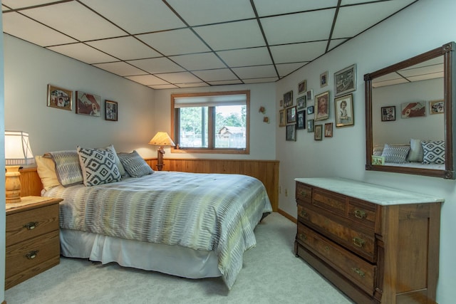 bedroom featuring carpet floors and a paneled ceiling