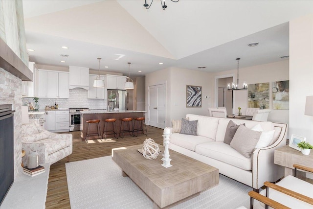 2229 Sharon Ln, Hudson, WI 54016 - living area featuring lofted ceiling, wood finished floors, recessed lighting, and a chandelier
