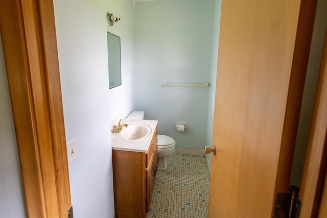 bathroom featuring vanity, tile patterned flooring, and toilet