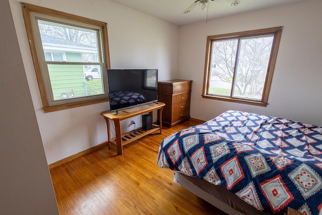 bedroom with light wood-style floors and baseboards