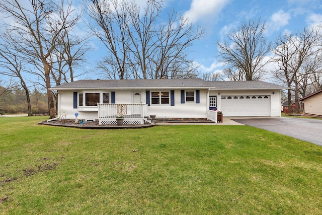 ranch-style house with an attached garage, a front yard, and aphalt driveway