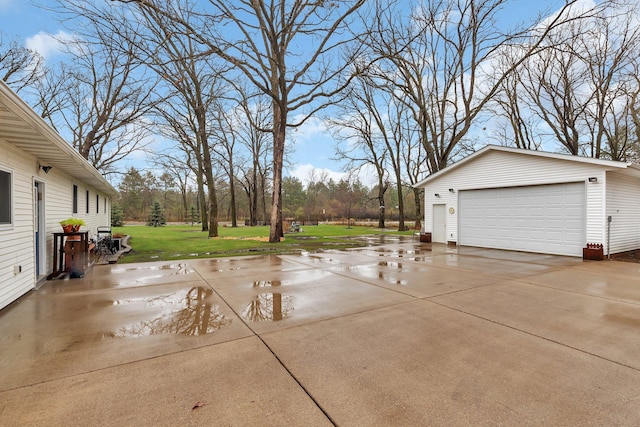 view of patio / terrace featuring a detached garage and an outdoor structure
