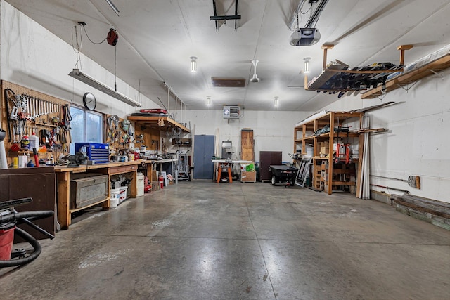 garage with a workshop area and a garage door opener