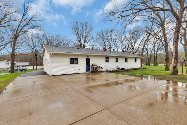 rear view of house featuring a yard