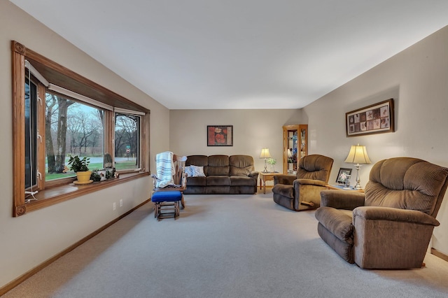 carpeted living room featuring baseboards