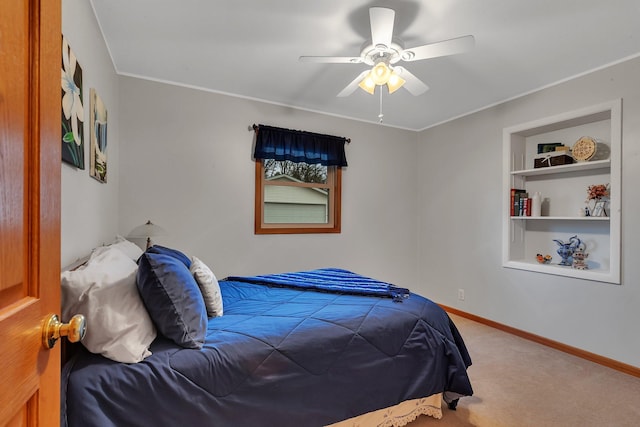 bedroom featuring a ceiling fan, baseboards, ornamental molding, and carpet