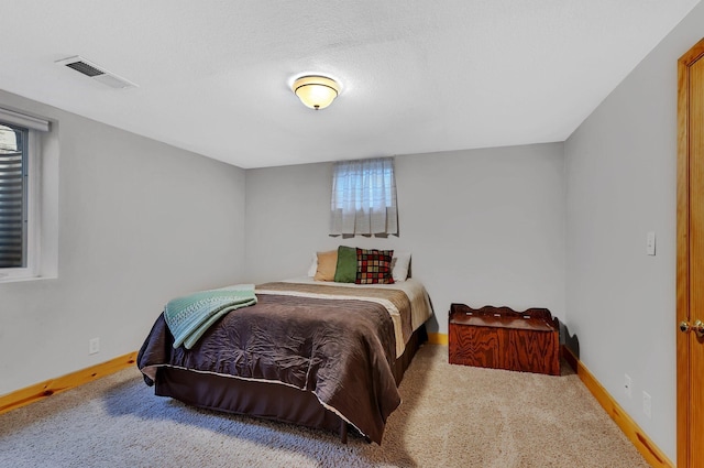 bedroom featuring baseboards, multiple windows, carpet flooring, and visible vents