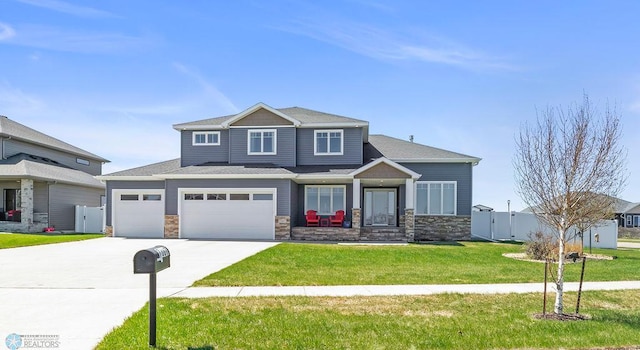 craftsman-style house featuring fence, a front lawn, stone siding, and driveway