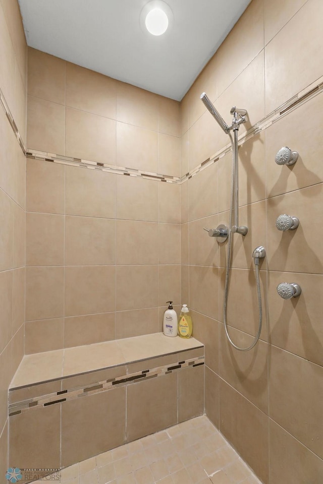 bathroom with a tile shower