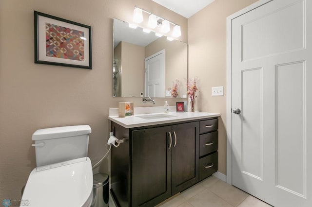 bathroom featuring tile patterned floors, toilet, and vanity