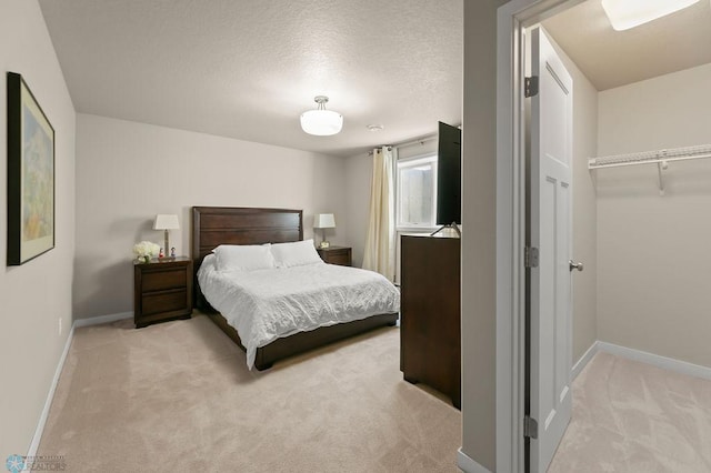 bedroom with light carpet and baseboards