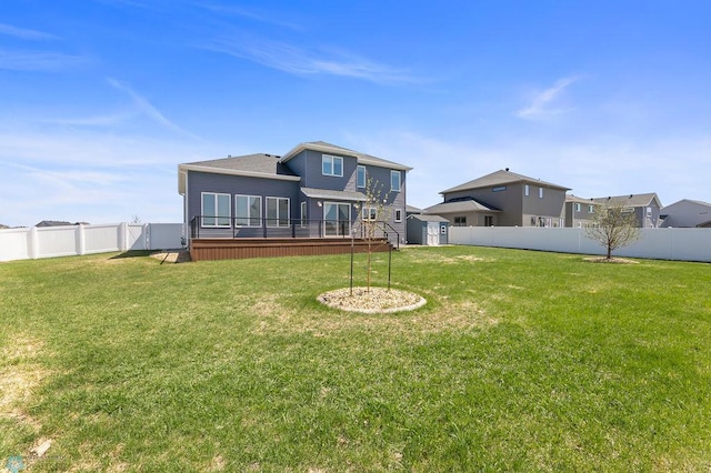 rear view of property with a fenced backyard, an outdoor structure, a shed, and a lawn