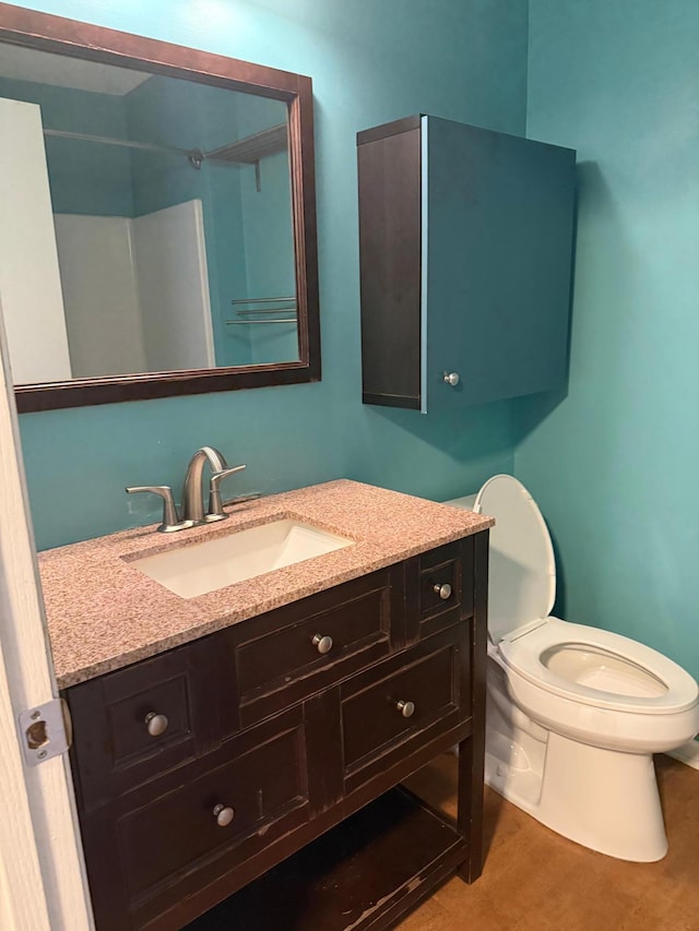 bathroom featuring vanity, toilet, and wood finished floors