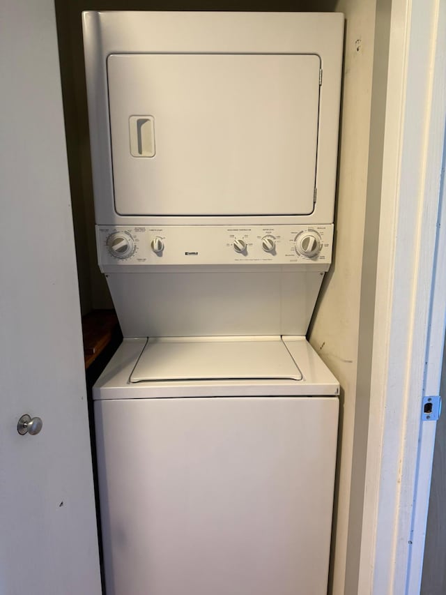 clothes washing area featuring laundry area and stacked washer and dryer