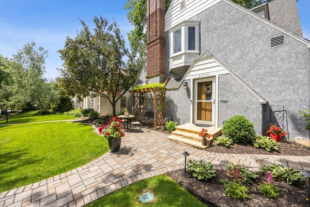 4904 11th Ave S, Minneapolis, MN 55417 - view of front of home featuring stucco siding, a front yard, and a patio area