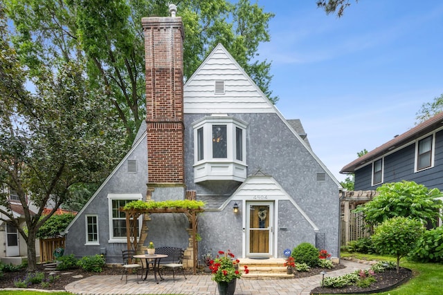 4904 11th Ave S, Minneapolis, MN 55417 - view of front of home with a chimney, stucco siding, and a patio area