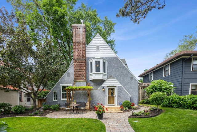 4904 11th Ave S, Minneapolis, MN 55417 - view of front of property with a chimney, a front yard, a patio, and stucco siding