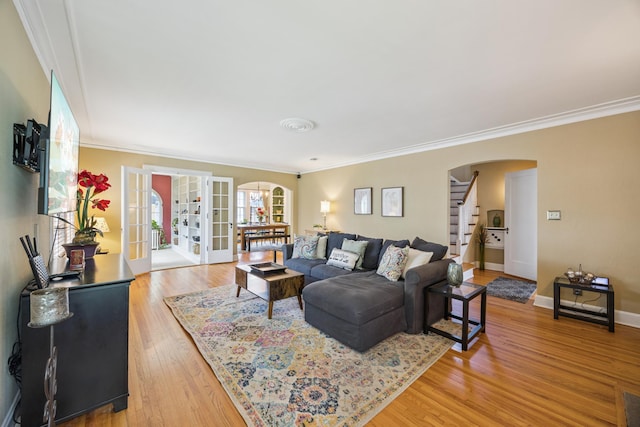 4904 11th Ave S, Minneapolis, MN 55417 - living area featuring arched walkways, stairs, ornamental molding, light wood-style flooring, and french doors