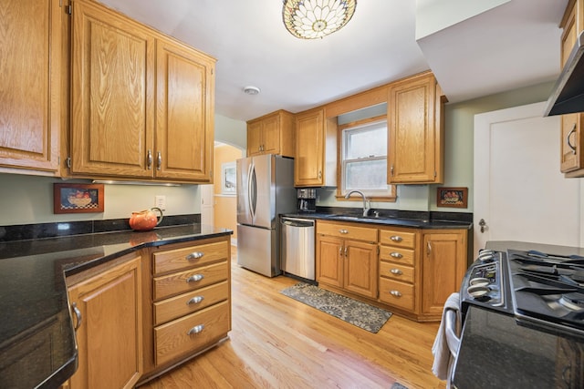 4904 11th Ave S, Minneapolis, MN 55417 - kitchen featuring stainless steel appliances, light wood finished floors, and brown cabinetry