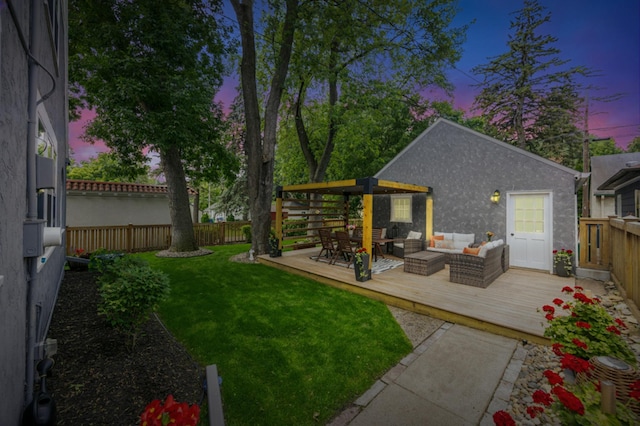 4904 11th Ave S, Minneapolis, MN 55417 - yard at dusk featuring an outdoor hangout area, a deck, and a fenced backyard