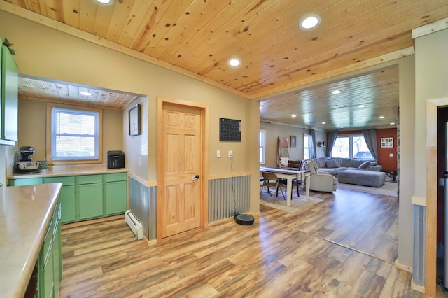 kitchen featuring light wood-style floors, light countertops, wood ceiling, a baseboard heating unit, and green cabinets