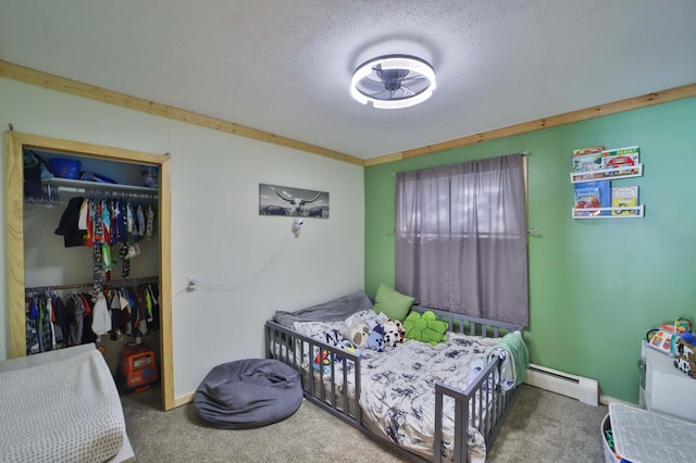 bedroom featuring a textured ceiling, carpet, baseboards, a baseboard radiator, and a closet