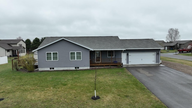 ranch-style home with a porch, a front lawn, aphalt driveway, roof with shingles, and an attached garage