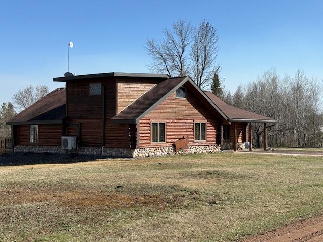view of side of home featuring a yard