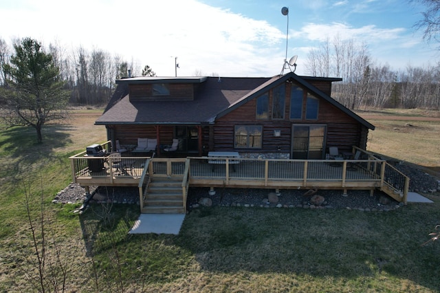 back of house with a wooden deck, a yard, and log siding