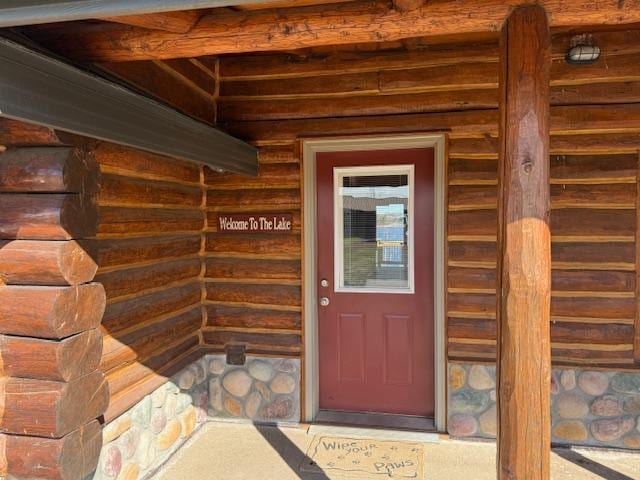 doorway to property featuring stone siding