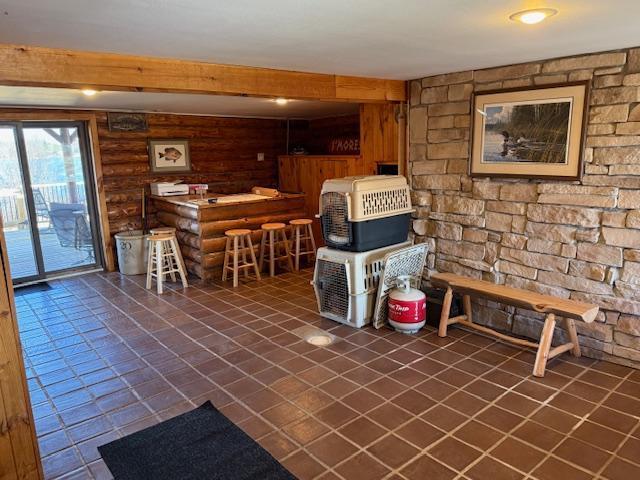 interior space featuring beam ceiling and dark tile patterned flooring