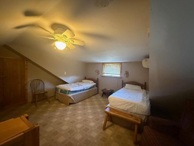 bedroom with a ceiling fan and vaulted ceiling