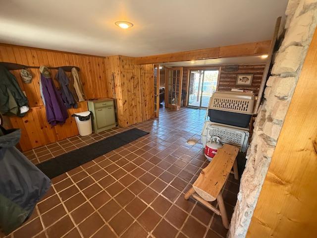 living area featuring wood walls