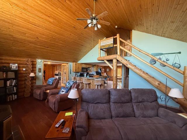living room featuring wood finished floors, wood ceiling, high vaulted ceiling, a ceiling fan, and log walls