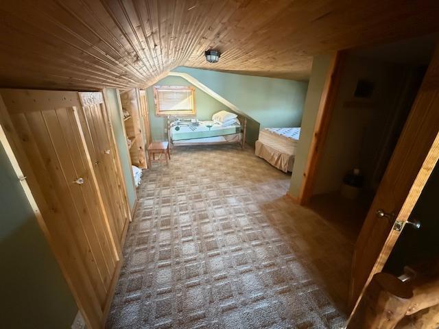 bedroom featuring wooden ceiling and vaulted ceiling