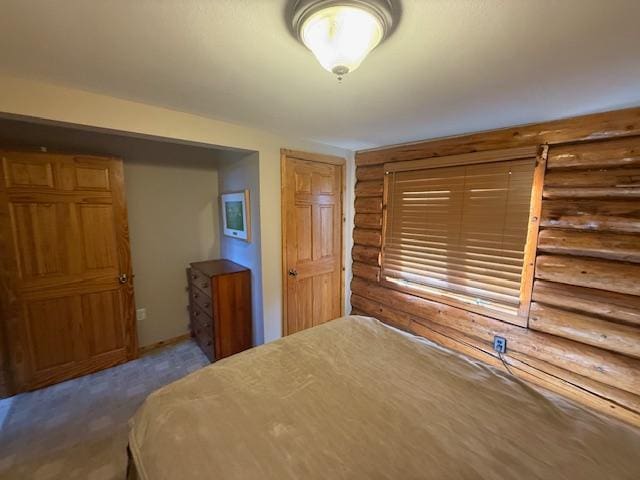 bedroom with rustic walls and carpet