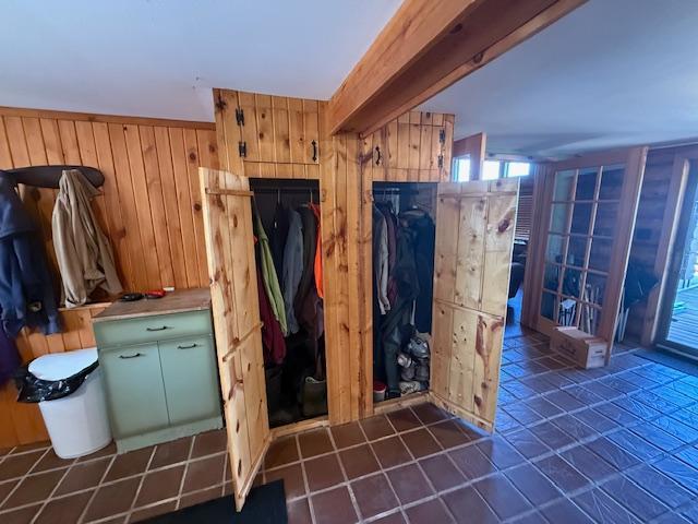 mudroom featuring wood walls