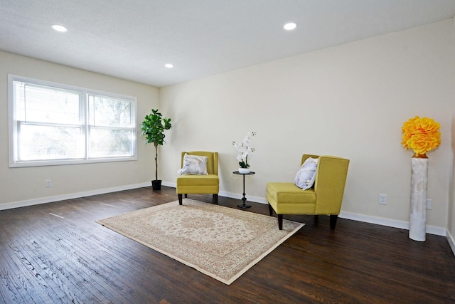 sitting room featuring baseboards, recessed lighting, and wood finished floors