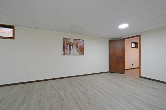 below grade area with baseboards and wood finished floors