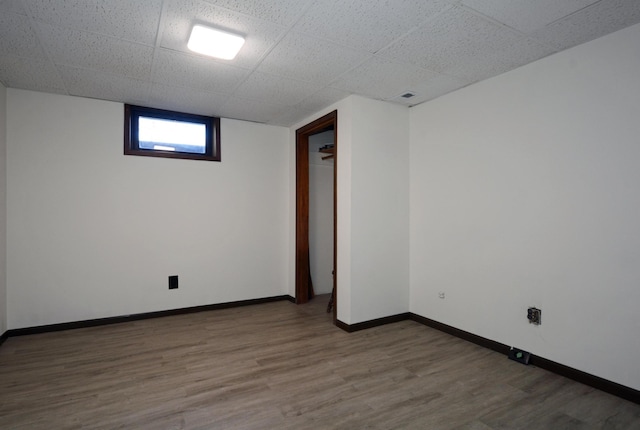 empty room with baseboards and wood finished floors